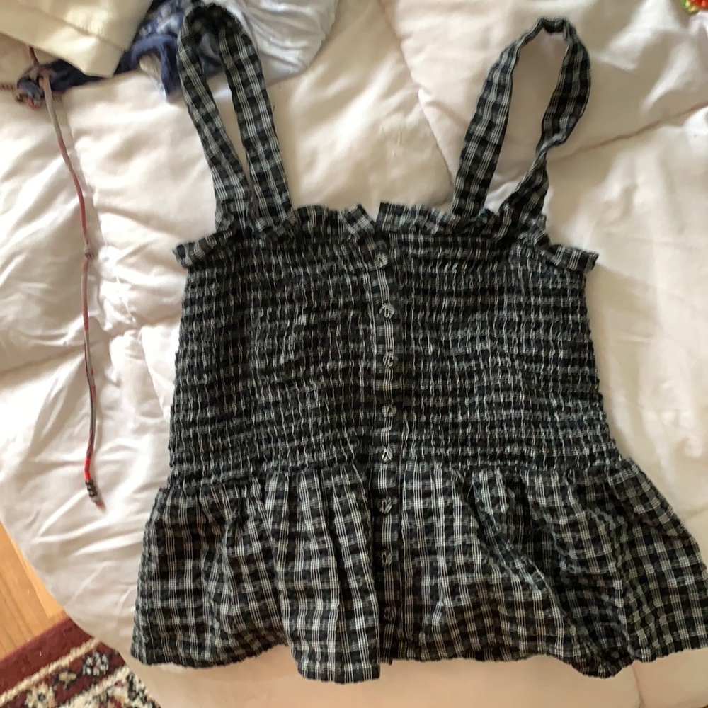 Cute tank. Tight and for fitting. Ruffle on bottom. Black and white.